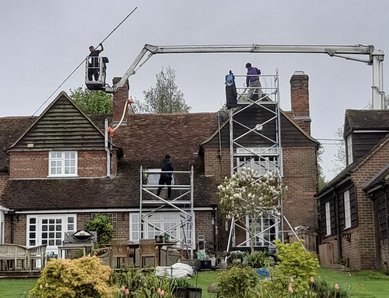 The Moss Cleaners using cherry picker and scaffolding to clean roof safely and professionally in Bexley, London